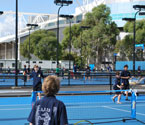 Students participating in a range of tennis activities
