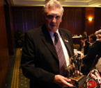Mr. Phil Gilbert (President of the Ipswich Sub Branch RSL) holding Sands of Gallipoli figurine
